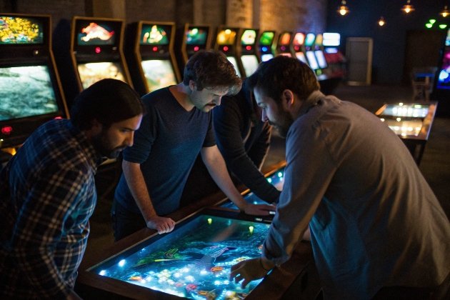 Group of friends enjoying multiplayer underwater touchscreen game