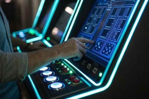 Businessmen playing slot machines in modern gaming room