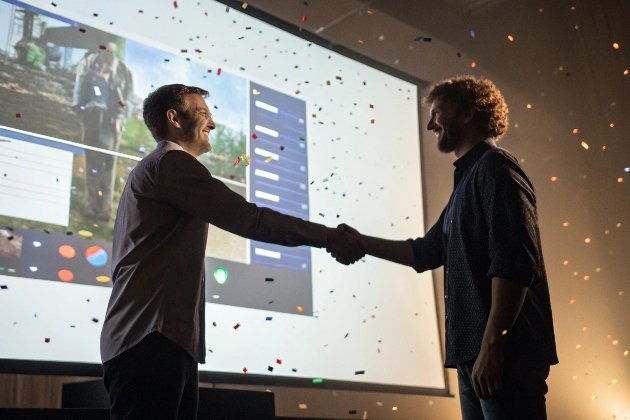 Partnership Handshake Business partners shaking hands amid celebratory confetti